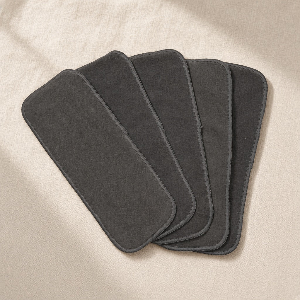 Five charcoal bamboo nappy inserts fanned out